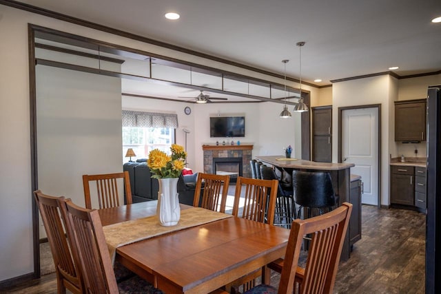 dining room featuring ceiling fan, ornamental molding, and dark hardwood / wood-style flooring