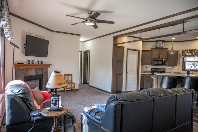 carpeted living room featuring crown molding and ceiling fan