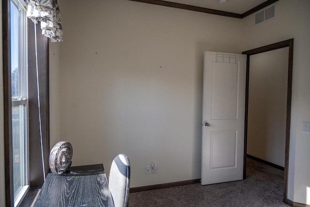 unfurnished office with crown molding and dark colored carpet