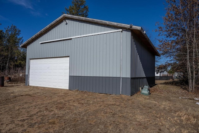 view of side of home featuring an outbuilding and a garage