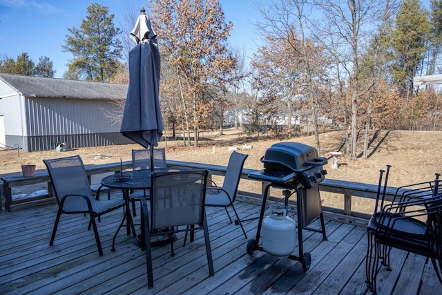 wooden terrace with a grill