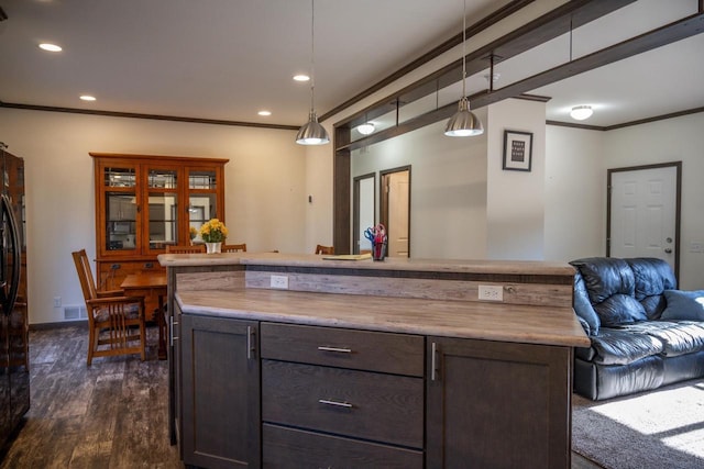 bar with crown molding, dark brown cabinets, dark hardwood / wood-style flooring, and hanging light fixtures