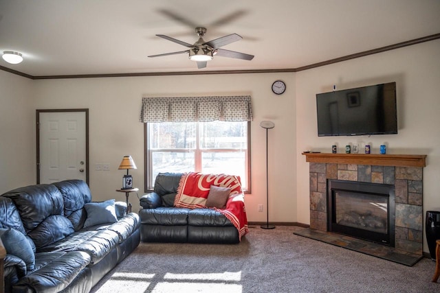 carpeted living room with crown molding, a fireplace, and ceiling fan