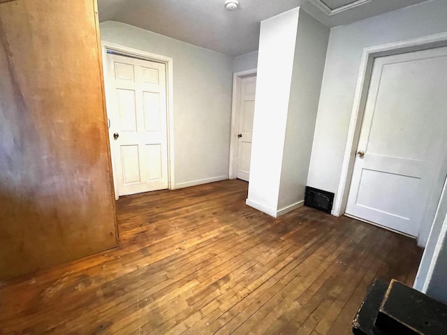 unfurnished bedroom featuring dark wood-type flooring