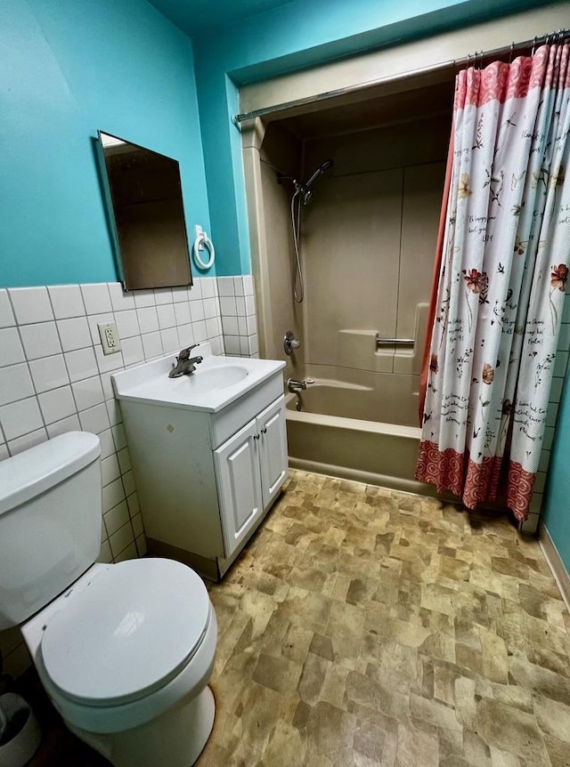 full bathroom with vanity, tile walls, shower / tub combo, and toilet