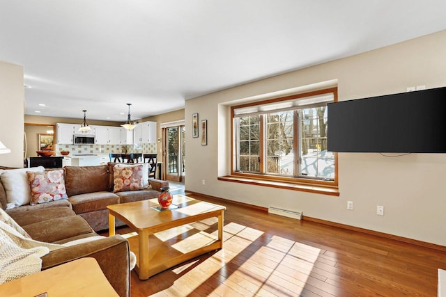 living room with light hardwood / wood-style floors and a baseboard radiator