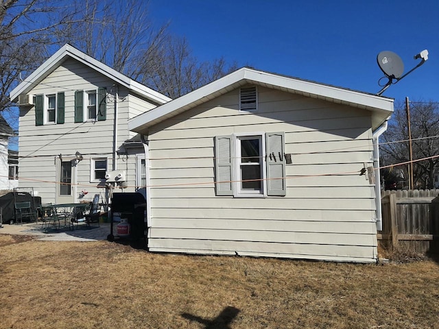 view of property exterior featuring a lawn and a patio