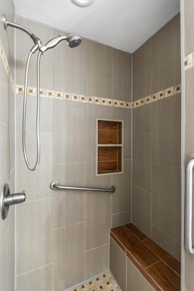 bathroom with tiled shower