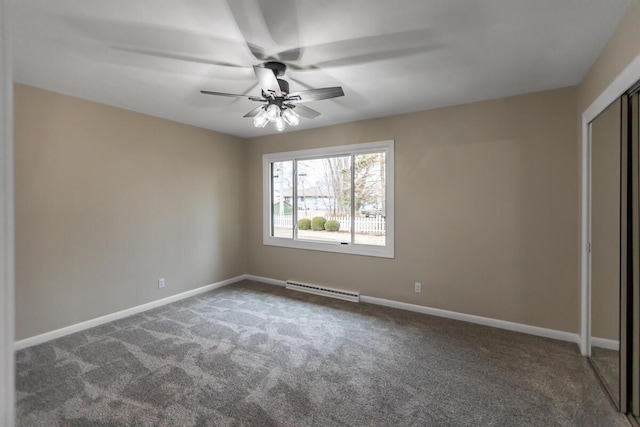 unfurnished bedroom with dark colored carpet, ceiling fan, and a closet