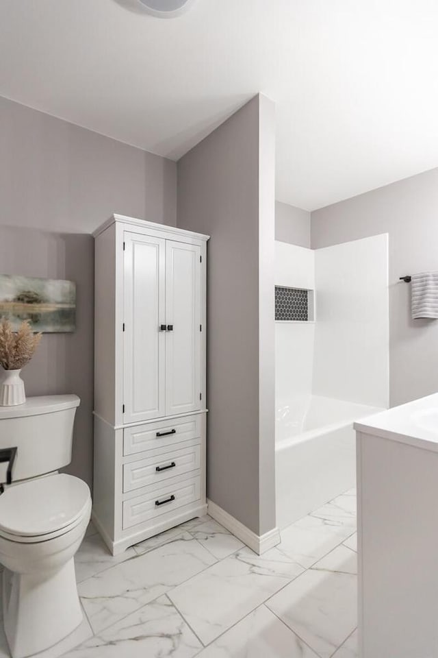 bathroom featuring vanity, toilet, and a tub