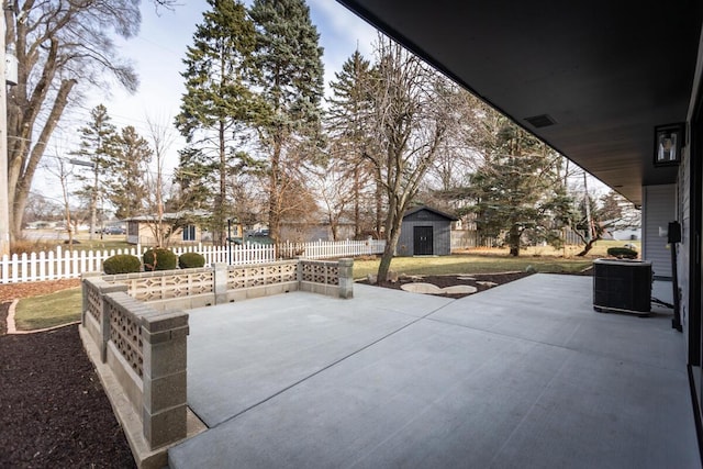 view of patio / terrace with a shed and central AC