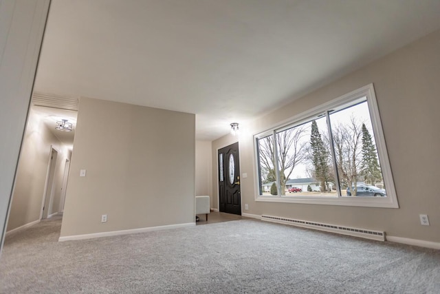 carpeted spare room with a baseboard radiator