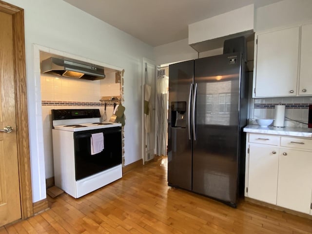 kitchen with electric stove, white cabinetry, exhaust hood, and stainless steel refrigerator with ice dispenser