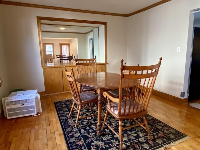 dining room with crown molding, wood-type flooring, and a wall unit AC