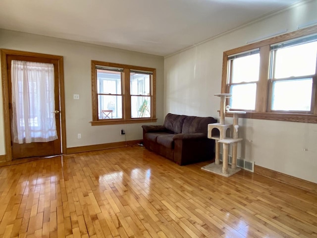 unfurnished living room with light hardwood / wood-style flooring and a wealth of natural light