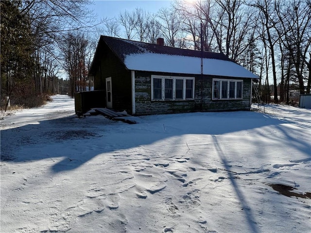 view of snow covered back of property