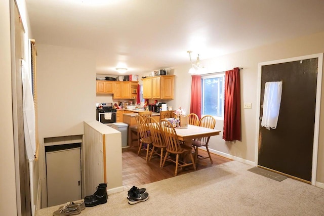 dining area featuring light colored carpet and sink