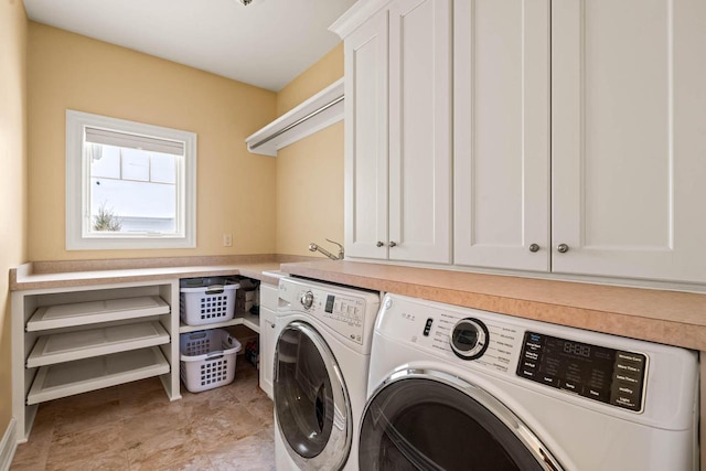 laundry room with independent washer and dryer and cabinets