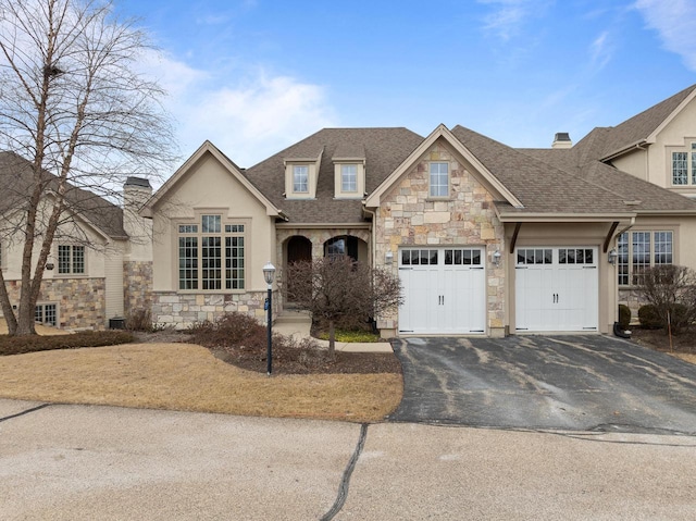 view of front of home with a garage and central AC