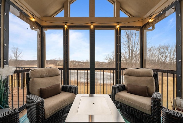 sunroom / solarium with vaulted ceiling and a healthy amount of sunlight