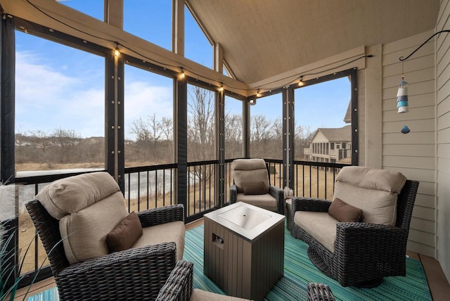 sunroom / solarium with vaulted ceiling and a healthy amount of sunlight