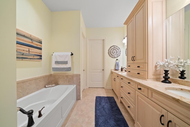 bathroom with tile patterned floors, a bathtub, and vanity