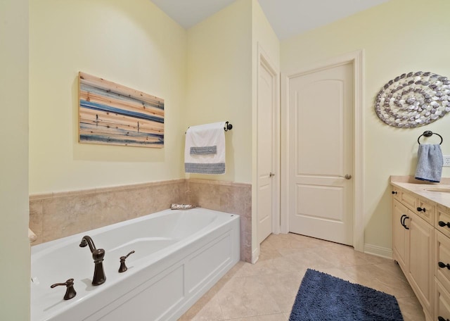 bathroom with vanity, a washtub, and tile patterned floors