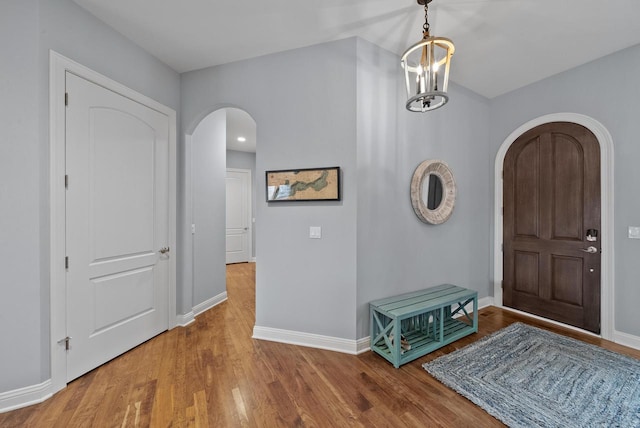 foyer featuring hardwood / wood-style flooring and a notable chandelier