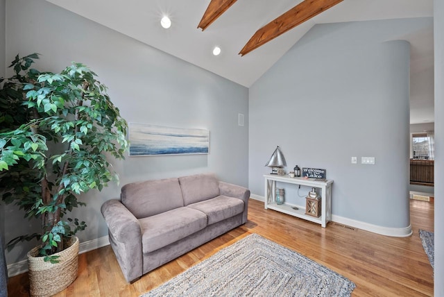 living room with lofted ceiling with beams and hardwood / wood-style floors