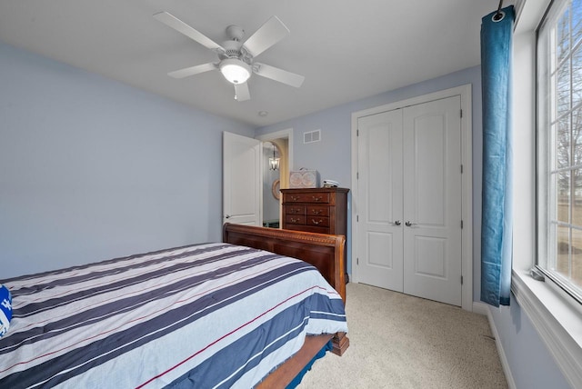 bedroom with light colored carpet, a closet, and ceiling fan