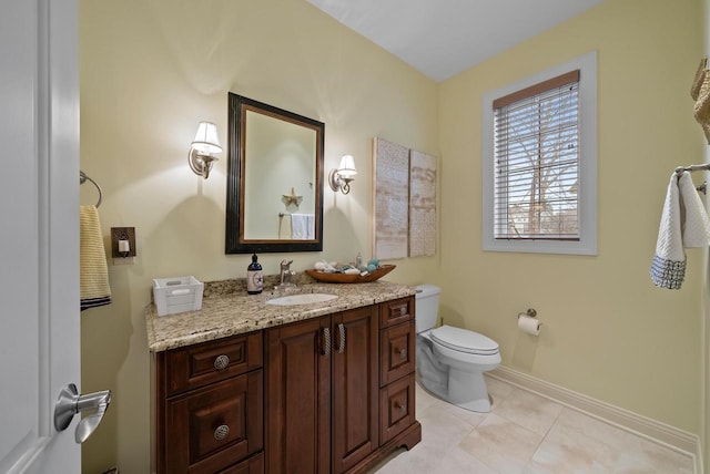 bathroom featuring tile patterned floors, vanity, and toilet