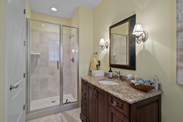 bathroom featuring vanity and a shower with door