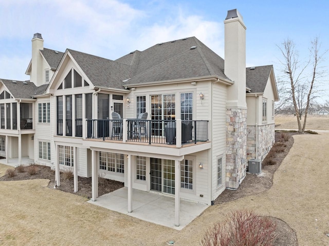 rear view of property featuring a patio, a yard, and cooling unit