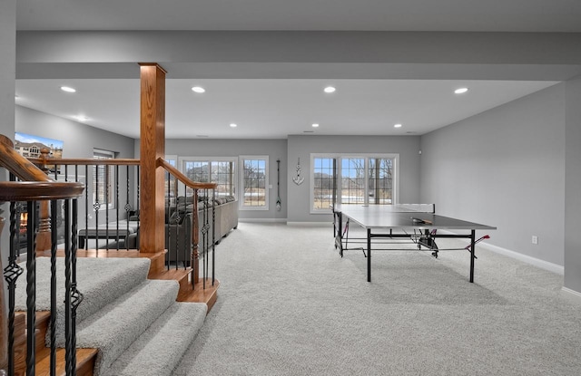 recreation room with light colored carpet