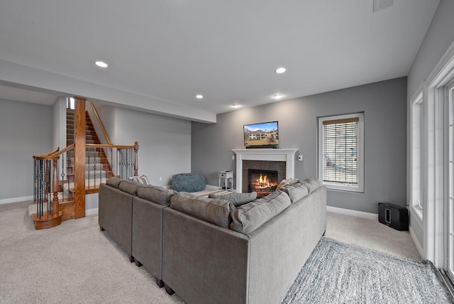 living room with light carpet and a tile fireplace