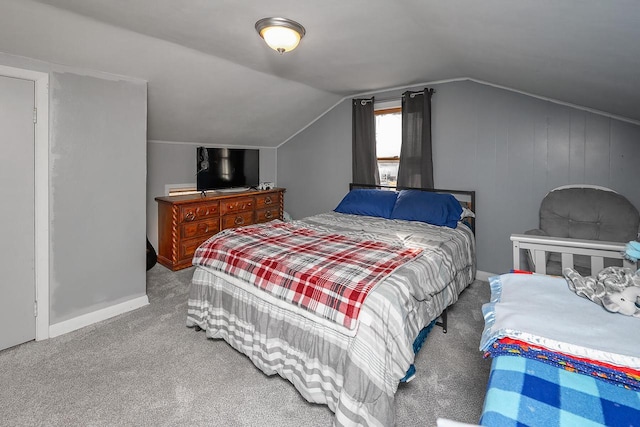 bedroom with vaulted ceiling and light colored carpet