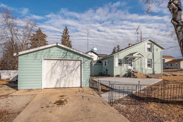 exterior space featuring a garage and an outbuilding