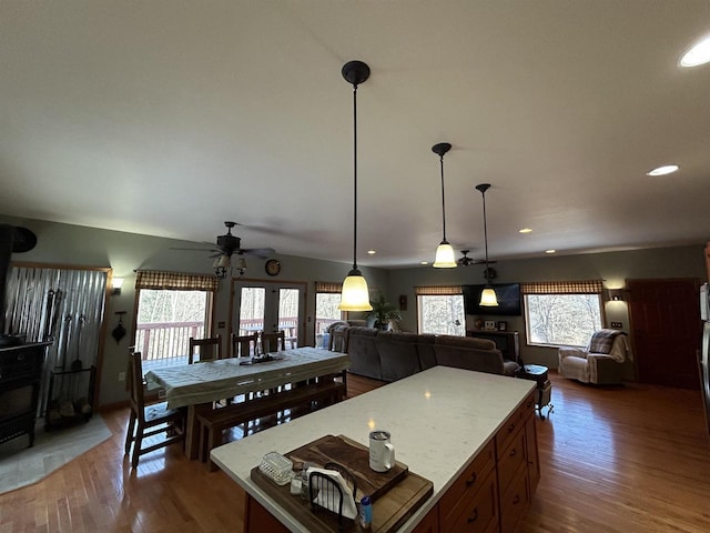 kitchen with dark wood-type flooring, recessed lighting, open floor plan, and a kitchen island