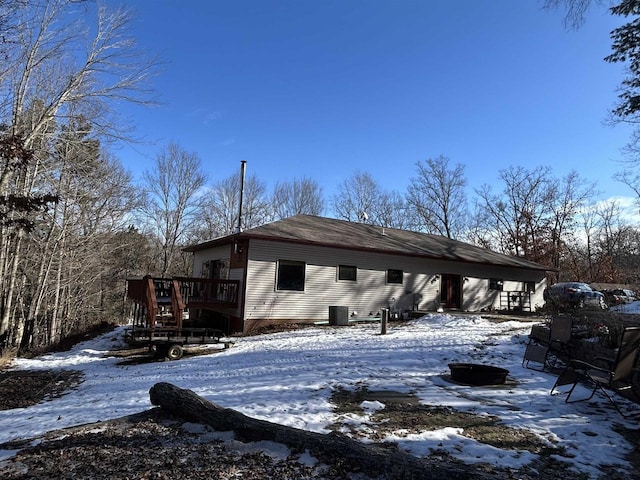 view of snow covered exterior featuring a deck and central air condition unit