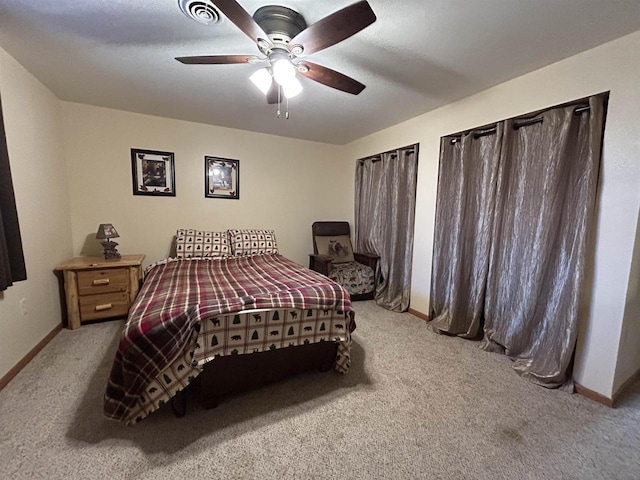 bedroom featuring visible vents, baseboards, a ceiling fan, and light colored carpet