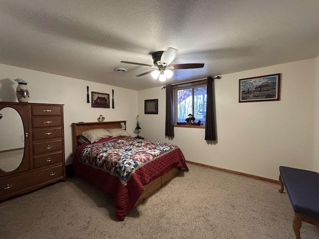 bedroom featuring baseboards, visible vents, ceiling fan, a textured ceiling, and carpet flooring