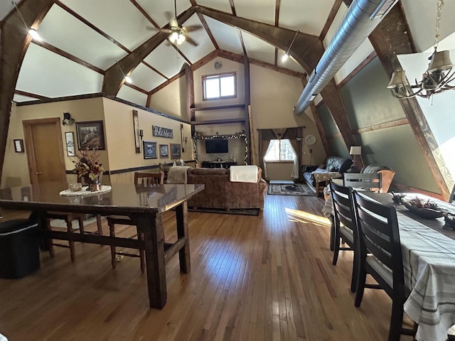 dining area featuring high vaulted ceiling, ceiling fan, and wood finished floors