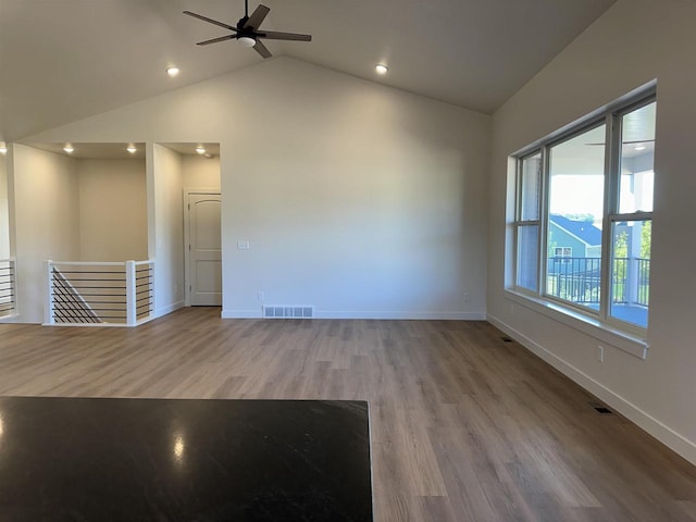 unfurnished room featuring ceiling fan, vaulted ceiling, and light hardwood / wood-style flooring