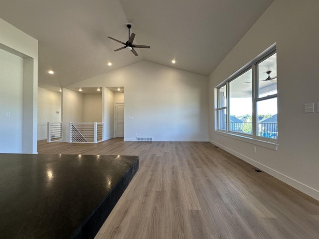 spare room featuring lofted ceiling, hardwood / wood-style flooring, and ceiling fan