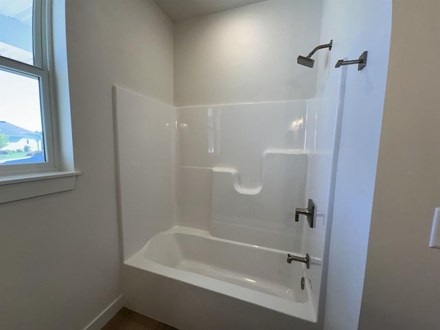 bathroom with bathing tub / shower combination