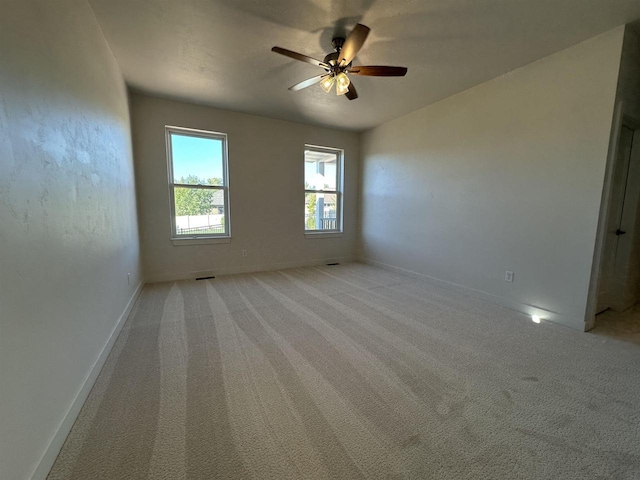 spare room with light colored carpet and ceiling fan