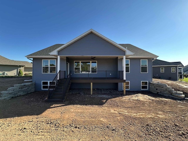 rear view of property featuring covered porch