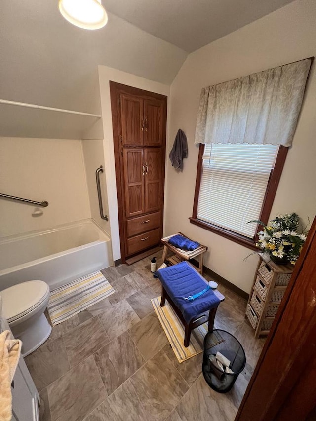 bathroom featuring vaulted ceiling and toilet