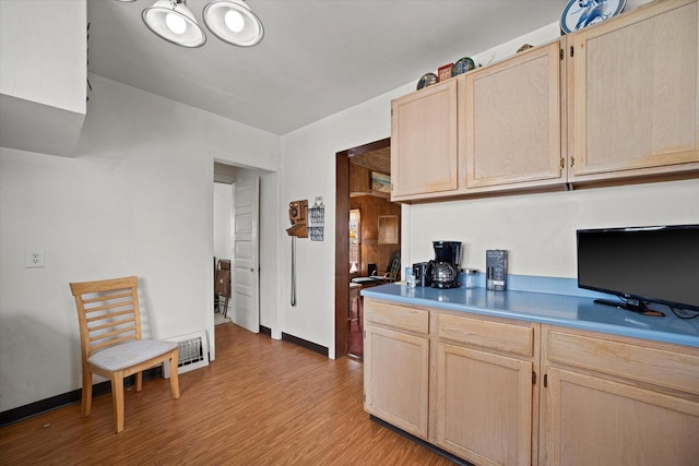 kitchen featuring light brown cabinetry and light hardwood / wood-style floors