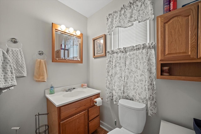 bathroom featuring vanity and toilet